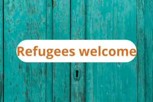 Sign on a door saying "refugees welcome"
