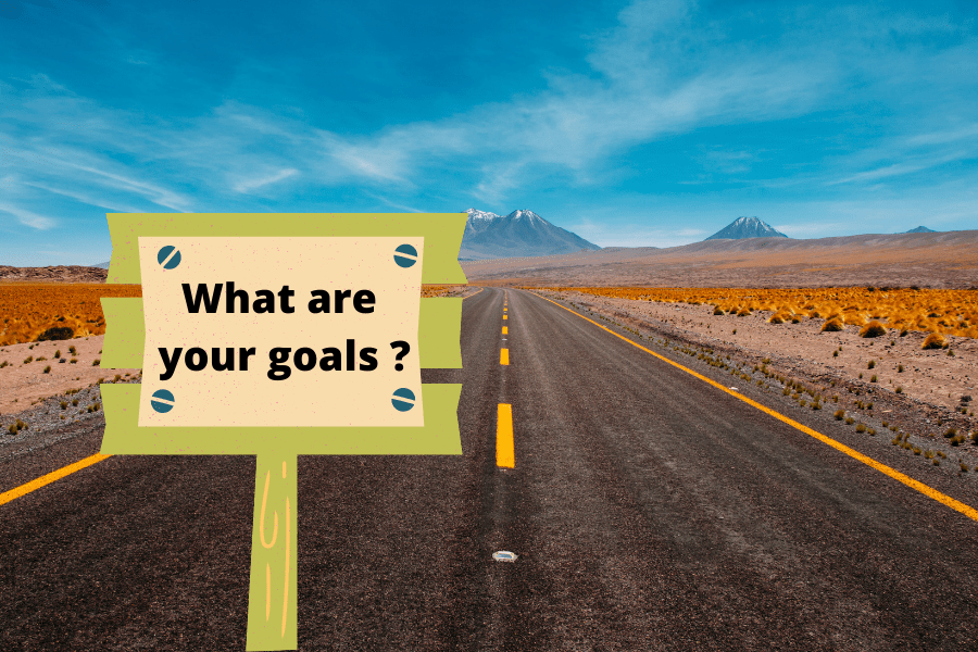 Road with a sign saying "What are your goals?" And you, what are your language learning goals?