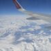 View from the plane overlooking the snowy Alps